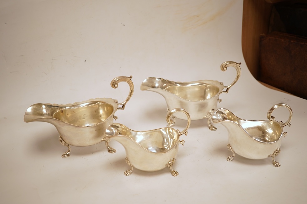A pair of George V silver sauceboats, with cut borders and flying scroll handles, on three hoof feet, by J.B. Chatterley & Co Ltd, Birmingham, 1928, length 19.3cm, 19.3oz, together with a pair of silver plated Elkington